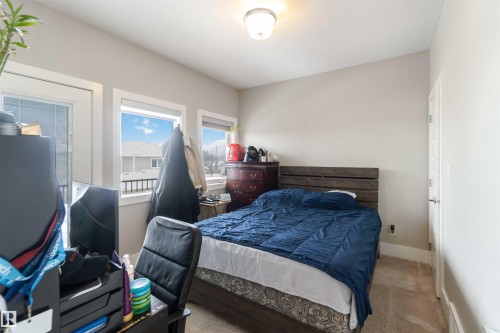 This room features light-colored walls, carpeted floors, and a ceiling light fixture - 4 Lakeshore Cove, Beaumont, AB 