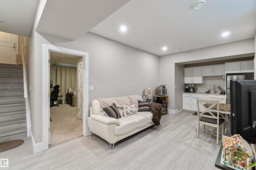 The living area features light-colored walls, recessed lighting, and light wood-style flooring - 4 Lakeshore Cove, Beaumont, AB 
