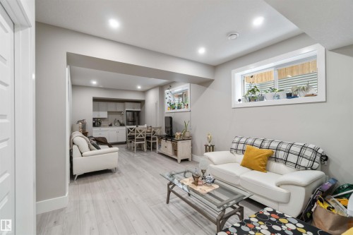 Living area featuring light-toned flooring, recessed lighting, and a white window frame - 4 Lakeshore Cove, Beaumont, AB 