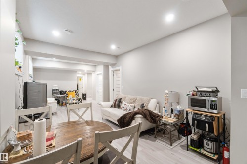 Open concept living area featuring light-toned flooring and neutral walls - 4 Lakeshore Cove, Beaumont, AB 