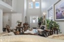 The property features high ceilings, a grand entryway with a transom window and sidelights, and a second-story interior balcony overlooking the main living area - 4 Lakeshore Cove, Beaumont, AB 