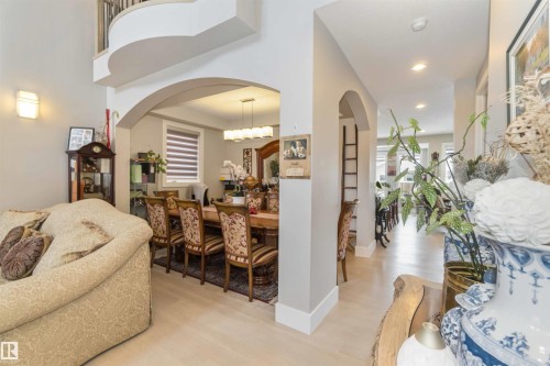 Spacious interior with arched doorways, light-colored flooring, and recessed lighting - 4 Lakeshore Cove, Beaumont, AB 