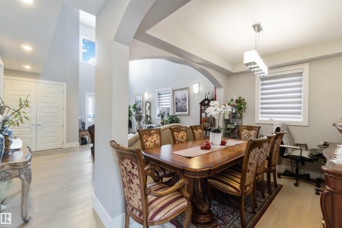 The property features an open-concept interior with light-colored flooring and a high window providing natural light - 4 Lakeshore Cove, Beaumont, AB 