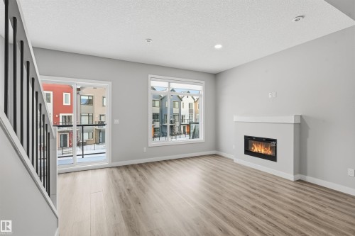 80 1010 Rabbit Hill Road, Edmonton, AB - Indoor Photo Showing Living Room With Fireplace