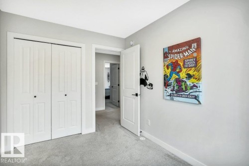 This room features light gray walls and plush gray carpeting - 99 1010 Rabbit Hill Road, Edmonton, AB - Indoor
