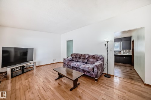 This living area features light wood flooring and white walls - 4237 116 Avenue, Edmonton, AB - Indoor Photo Showing Living Room