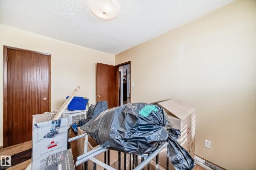 The room features cream-colored walls and a textured ceiling with an overhead light fixture - 4237 116 Avenue, Edmonton, AB - Indoor