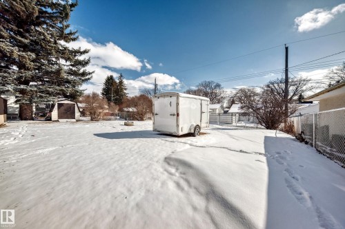 The property features a spacious yard with mature trees and a shed - 4237 116 Avenue, Edmonton, AB - Outdoor