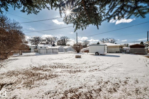 The property features a spacious yard with a fence, and a clear view of the surrounding neighborhood - 4237 116 Avenue, Edmonton, AB - Outdoor