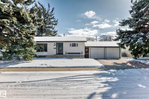 The property features a white exterior, a two-car garage, and a driveway - 4237 116 Avenue, Edmonton, AB - Outdoor