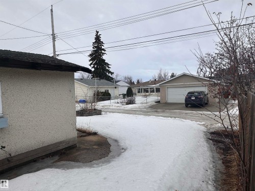 The property features a private drive and a detached structure with a pitched roof - 9724 102 Avenue, Westlock, AB - Outdoor