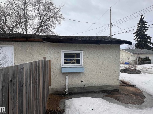Exterior view of the property featuring a window with a window box and a wooden fence - 9724 102 Avenue, Westlock, AB - Outdoor