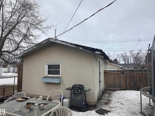 The property features an exterior building with a window and a wooden fence - 9724 102 Avenue, Westlock, AB - Outdoor With Exterior