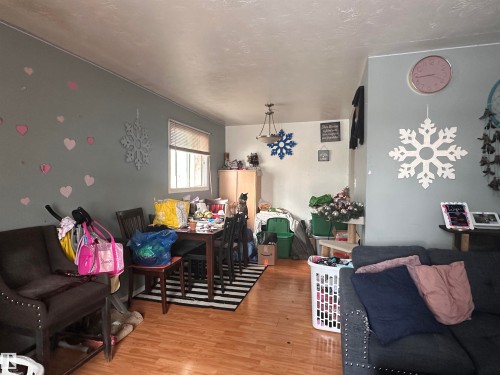 The property features hardwood style flooring throughout this living area - 9724 102 Avenue, Westlock, AB - Indoor Photo Showing Other Room