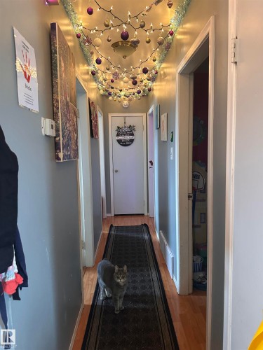 Hallway featuring wood flooring and light gray walls - 9724 102 Avenue, Westlock, AB - Indoor Photo Showing Other Room