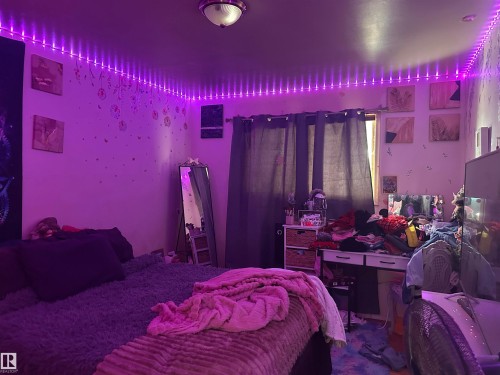 Interior room featuring wall-mounted lighting and a ceiling light fixture - 9724 102 Avenue, Westlock, AB - Indoor Photo Showing Bedroom