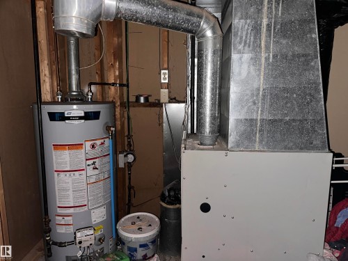 The property includes a water heater and a furnace unit - 9724 102 Avenue, Westlock, AB - Indoor Photo Showing Basement