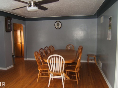 Dining room featuring hardwood floors and a ceiling fan with light - 5023 50 Street, Two Hills, AB - Indoor Photo Showing Dining Room