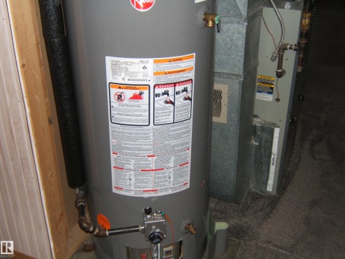 The property includes a water heater and a furnace - 5023 50 Street, Two Hills, AB - Indoor Photo Showing Basement