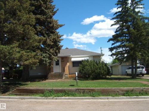 Single-story residence featuring a gabled roof, light-colored siding, and a front entrance with steps - 5023 50 Street, Two Hills, AB - Outdoor