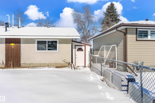 The property features an exterior with light-colored stucco and brown siding, a fenced yard, and a separate side entrance - 11 Sonora Drive, St. Albert, AB - Outdoor With Exterior