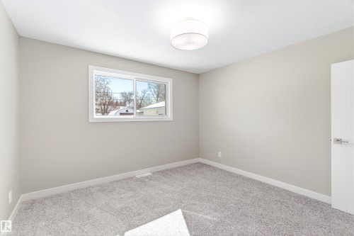 Interior room with light gray walls, gray carpet, a single window, and a white ceiling light fixture - 11 Sonora Drive, St. Albert, AB - Indoor Photo Showing Other Room