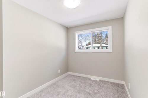 Room with light gray walls, gray carpet, and a window with white trim - 11 Sonora Drive, St. Albert, AB - Indoor Photo Showing Other Room