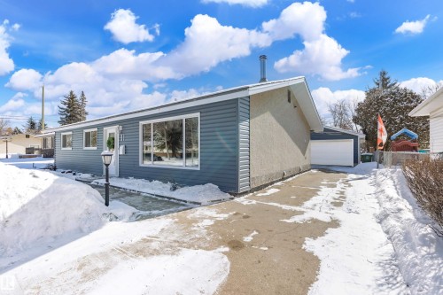 The property features a ranch-style exterior with blue siding and a light-colored stucco finish - 11 Sonora Drive, St. Albert, AB - Outdoor