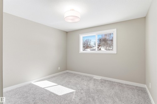 The property features an interior space with light gray walls, a window providing natural light, and plush gray carpeting - 11 Sonora Drive, St. Albert, AB - Indoor Photo Showing Other Room