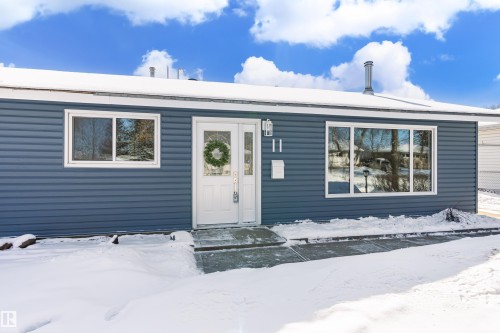 The property features a blue exterior with white trim and a white front door - 11 Sonora Drive, St. Albert, AB - Outdoor