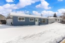 The property features blue horizontal siding, a white front door, and white window frames - 11 Sonora Drive, St. Albert, AB  - Outdoor 