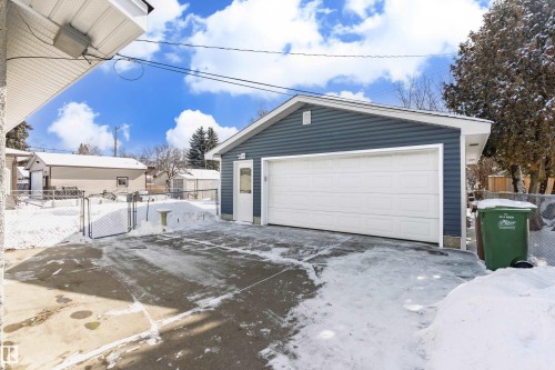 Detached garage with a white overhead door and blue siding - 11 Sonora Drive, St. Albert, AB - Outdoor With Exterior