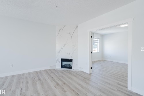 703 9919 105 Street, Edmonton, AB - Indoor With Fireplace