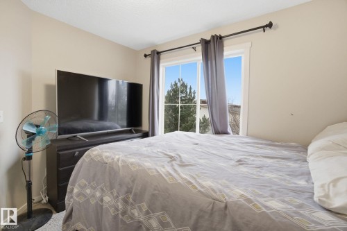 This room features a window with a view of greenery, complemented by light-colored walls - 75 603 Watt Boulevard, Edmonton, AB - Indoor Photo Showing Bedroom