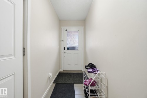 Entryway featuring a white door with a frosted glass insert and light-colored walls - 75 603 Watt Boulevard, Edmonton, AB - Indoor Photo Showing Other Room