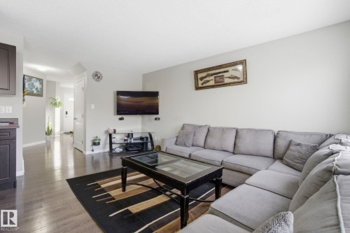 The living area features hardwood floors and light gray walls - 3026 16A Avenue, Edmonton, AB - Indoor Photo Showing Living Room