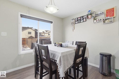 The dining area features light-colored walls, a large window, and wood-style flooring - 3026 16A Avenue, Edmonton, AB - Indoor Photo Showing Dining Room