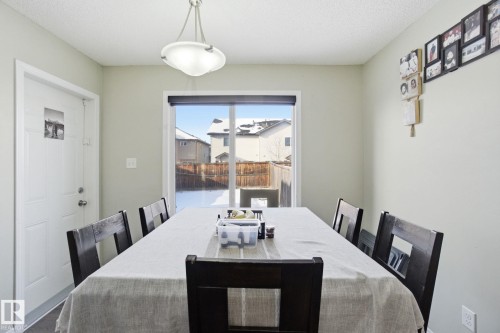 The dining area features a large window, providing natural light and views of the exterior - 3026 16A Avenue, Edmonton, AB - Indoor Photo Showing Dining Room