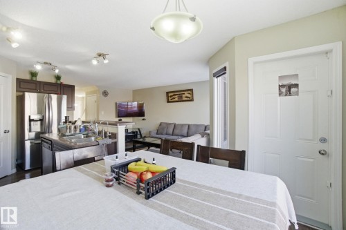 The open concept layout seamlessly integrates the kitchen and living areas - 3026 16A Avenue, Edmonton, AB - Indoor