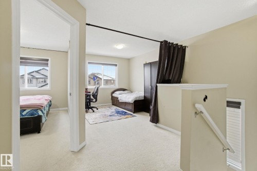 Well-lit room with carpeted flooring and windows providing natural light - 3026 16A Avenue, Edmonton, AB - Indoor