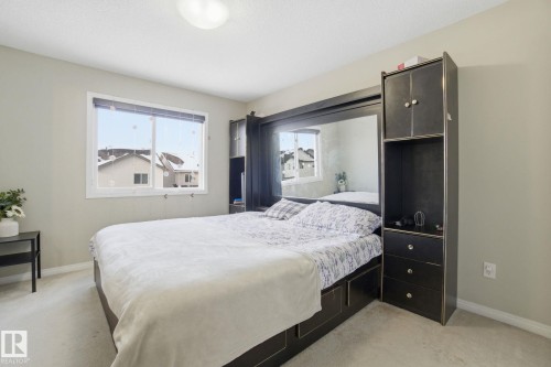 The property features an accommodating sleeping area with a window providing exterior views - 3026 16A Avenue, Edmonton, AB - Indoor Photo Showing Bedroom
