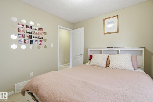 This room features light-colored walls and carpet flooring, providing a neutral backdrop - 3026 16A Avenue, Edmonton, AB - Indoor Photo Showing Bedroom