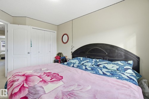 Bedroom featuring a neutral wall color, white ceiling, and white closet doors - 3026 16A Avenue, Edmonton, AB - Indoor Photo Showing Bedroom