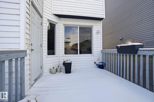 The property features a private deck with a wooden railing and an exterior door - 3026 16A Avenue, Edmonton, AB - Outdoor With Exterior