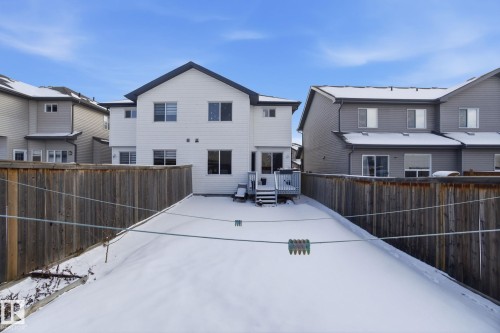 The property features a private fenced yard with a deck and steps leading to the outdoor space - 3026 16A Avenue, Edmonton, AB - Outdoor With Exterior