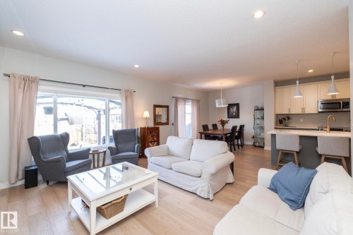 Spacious open-concept living area featuring light-toned flooring, recessed lighting, and a large window providing natural light - 26 Ellice Bend, Fort Saskatchewan, AB - Indoor Photo Showing Living Room
