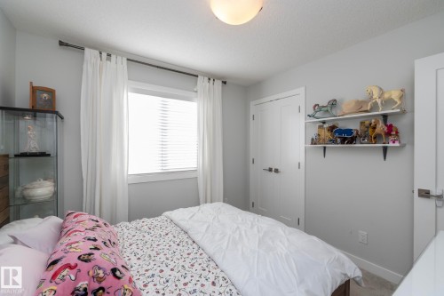 This room features a window with blinds and curtains, along with a flush mount ceiling light fixture - 26 Ellice Bend, Fort Saskatchewan, AB - Indoor Photo Showing Bedroom