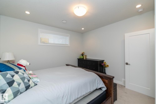 This room features light grey walls, recessed ceiling lights, and a white ceiling light fixture - 26 Ellice Bend, Fort Saskatchewan, AB - Indoor Photo Showing Bedroom
