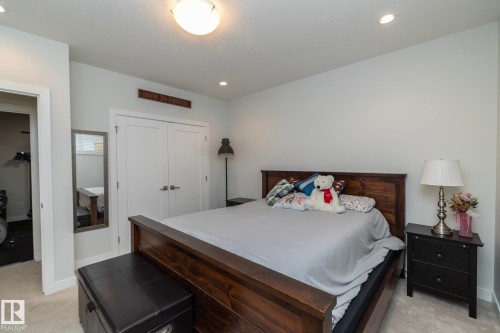 The property features a bedroom with neutral-toned walls and carpet flooring - 26 Ellice Bend, Fort Saskatchewan, AB - Indoor Photo Showing Bedroom