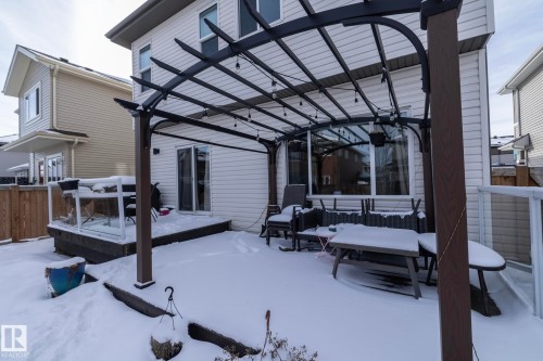 The exterior of the property features white siding and a large patio area with a pergola - 26 Ellice Bend, Fort Saskatchewan, AB - Outdoor With Exterior